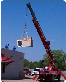 A crane is often used to set commercial rooftop HVAC units in Shawnee, Ok